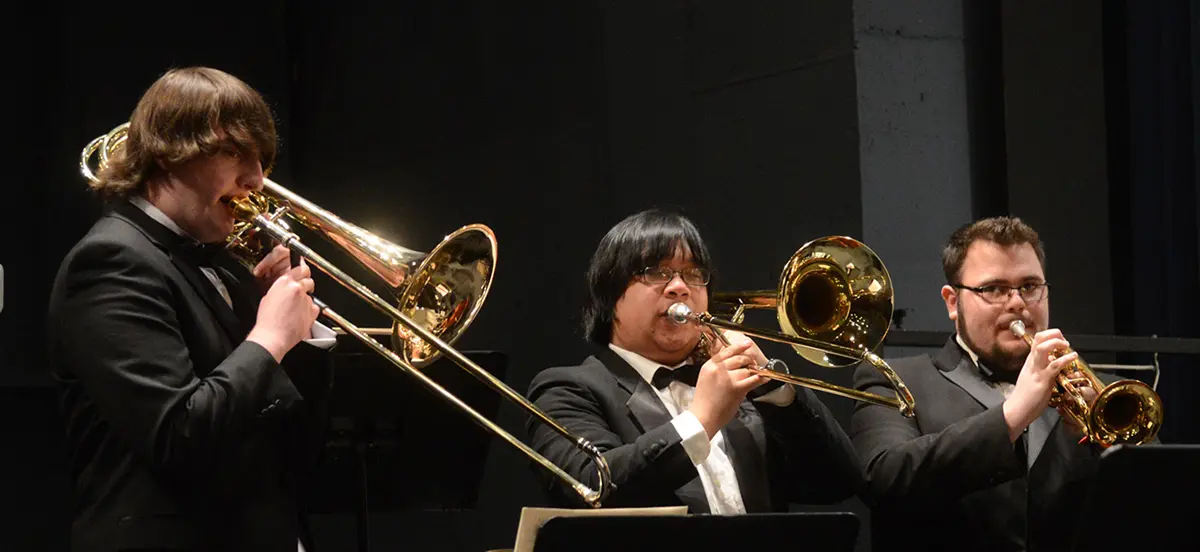 Three musicians in the brass section at the University Orchestra's "All You Need is Love!” Valentine's Day concert.