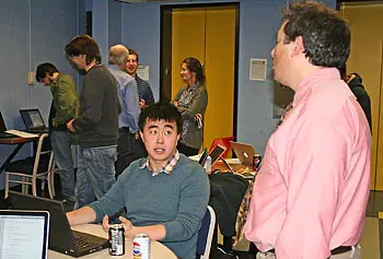 Computer science major Jonathan Yu explains his Blackjack Buddy project to Assoc. Prof. Fred Martin.