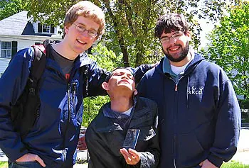 Matthew Campelli, left, and Ken Cramer, right, deliver their iPhone app to Rua Duong of Lowell.