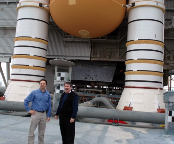 Profs. Avitabile & Niezrecki pose  next to the space shuttle endeavour's boosters during a tour in the winter of 2010.