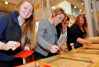 Speed up on the line! From left, students Makenna Campbell, Jacqueline DiPersio, Dena Cashin and Janelle Bourgeois experience some of the conditions that led to the Bread & Roses strike, in a simulation run by the Tsongas Industrial History Center.