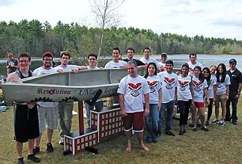 UMass Lowell&rsquo;s 2012 concrete canoe team poses with the &ldquo;Revolution.&rdquo;