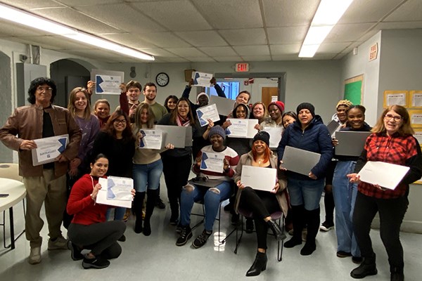 ESOL students at the Abisi Adult Education Center with their new Chromebooks and course certificates