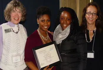 Imogene Stulken, left, of the Protestant Campus Ministry, presents a Splash! Award to members of the student organization SISTERS &ndash; Elena Lafortune, president and senior psychology major, and Thrisha Heaven, also a senior psychology major. Tracy Moore of Student Health Services, right, &nbsp;advises the group.