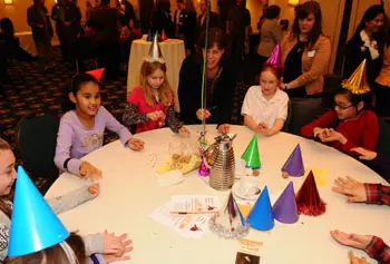 Girls Inc., a partner with UMass Lowell for "Dickens in Lowell," celebrated the author's 200th birthday with Victorian parlor games at the Inn & Conference Center.
