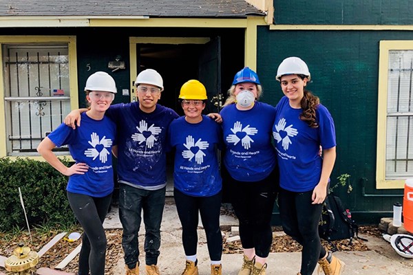 UML students stand in front of the house they helped rebuild in Houston