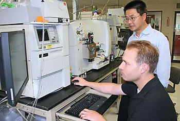 Asst. Prof. Jin Xu and postdoctoral researcher Tyler Carter at the Massachusetts BioManufacturing Center at UMass Lowell.