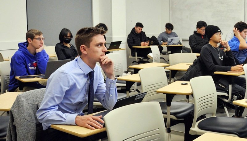 Jonah Burnham listening to lecture in class at UMass Lowell's Manning School of Business.