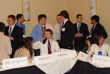 High school students at the Model U.N. Conference caucus to reach an agreement in committee.