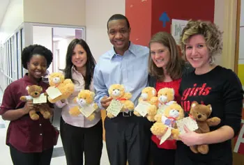 From left, Pascale Jean-Jacques, Connie Cabello and David Jones donated teddy bears made by UMass Lowell students during MLK Week to local organizations including representatives from Girls Inc. of Greater Lowell, right.