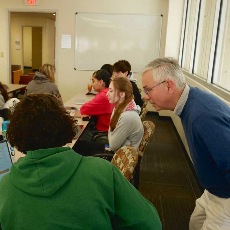 Professor speaks with a student in a World Languages & Cultures class at UMass Lowell.