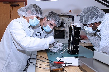 The SPACE HAUC team adding finishing touches to the satellite