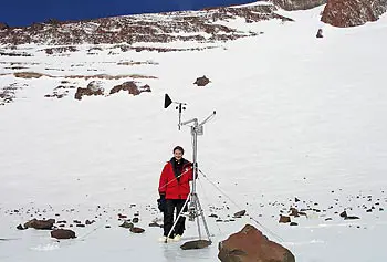 Asst. Prof. Kate Swanger poses next to the meteorological station at Mullins Glacier in Antarctica in this photo by Douglas Kowalewski of UMass Amherst.
