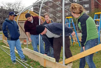 Will Deady, second from left, works with a crew of fellow students every weekend to build a community garden and greenhouse at UMass Lowell.