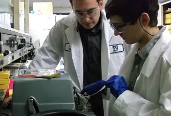 Andrew Sanginario, right, prepares brain tissue slices during his co-op work with Ph.D. student Brian Patuto.