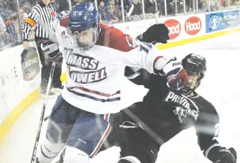 UMass Lowell's David Vallorani and Providence's Alex Velischek get physical in pursuit of the puck last night at Tsongas Center.