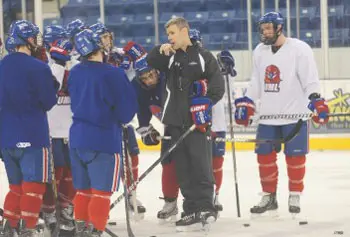 Coach Norm Bazin, center, runs through drills with the UMass Lowell hockey team at the Tsongas Center last Friday. Bazin, hired last spring, wasted no time turning the program around.