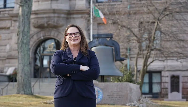 Katherine Moses in front of Lowell City Hall
