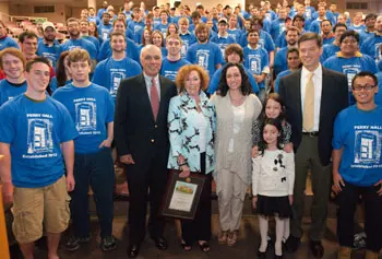 Barry Perry &rsquo;68, joined by his wife Janice, daughter Kimberly Perry, granddaughters Alix Perry Madden and Chase Madden Perry, and son-in-law Brian Madden, celebrate the re-dedication of the UMass Lowell Engineering Building with Plastics Engineering students, faculty and staff.