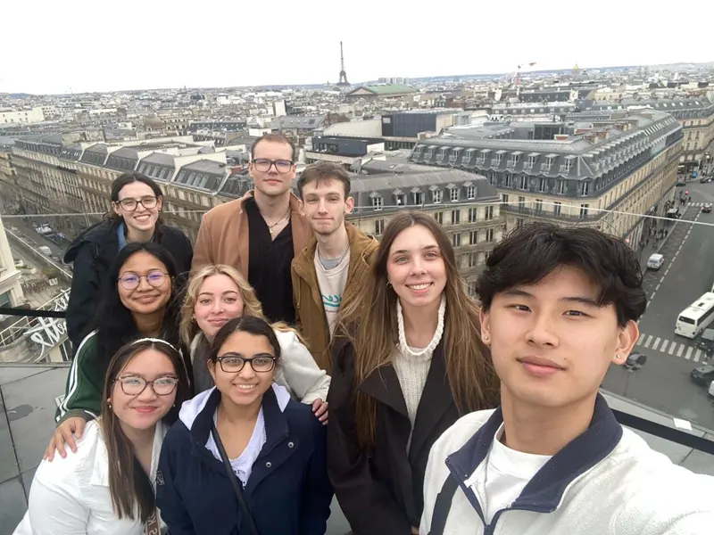 Rhondyna Reth poses with a group of UMass Lowell students in Paris.