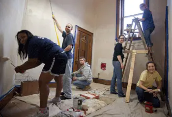 Members of UMass Lowell&rsquo;s Alternative Spring Break Club do some painting at the historic Pawtucket Congregational Church as part of the Lowell Immersion community service project.