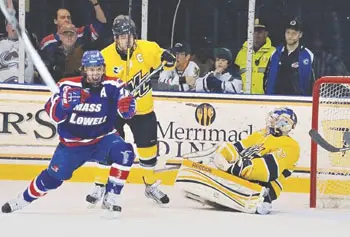 UMass Lowell's Josh Holmsrom scores one of his two goals to lead the River Hawks to a 3-1 win over Merrimack College in North Andover and into sole possession of first place in Hockey East the latest the River Hawks have ever been on top.