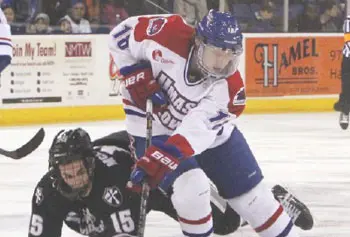 UMass Lowell's A.J. White skates past Providence's Steven McParland during Thursday night's game at the Tsongas Center. The River Hawks won, 2-1, for their eighth straight win.