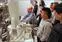 Lowell middle-school students listen to microscopy expert Christopher Santeufemio, seated, as he explains how a scanning electron microscope works.