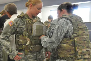 
          Army Specialst Arielle Mailloux gets some help adjusting her protoype Generation III Improved Outer Tactical Vest from Capt. Lindsey Pawlowski recently at Fort Campbell, Ky.&nbsp;Army photo by Megan Locke Simpson
        
