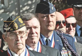 Members of the Squadron N-12 of the National Society of Pershing Rifles, from left, Al Kulas, Edward "Skip" Kittredge, Peter Maravelias, Joe Cartwright and Robert Nadeau, attend a Veterans Day flag-raising ceremony at UMass Lowell.&nbsp;