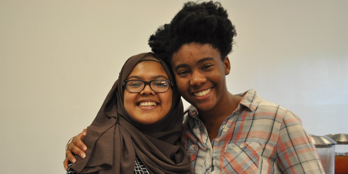 Two students with arms around each other