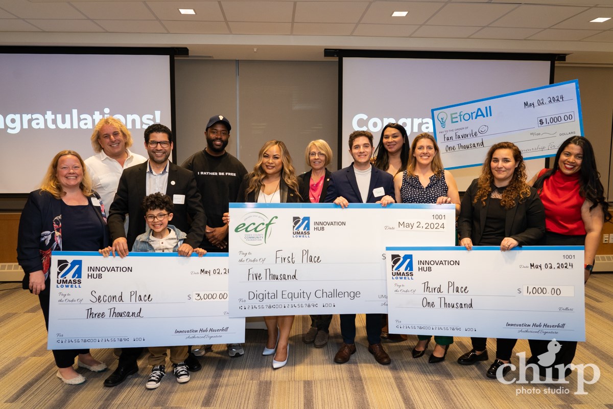 Digital Equity Challenge 2024 winners standing and holding large checks.