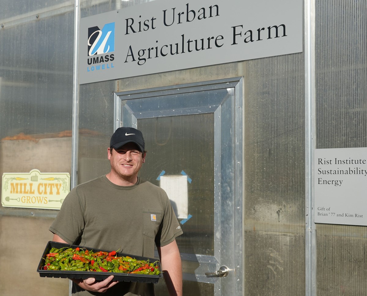 Chris Horne holds a tray of pepper at the Rist Urban Agriculture Farm.