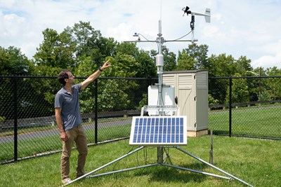 Christopher Skinner points at the pyranometer.