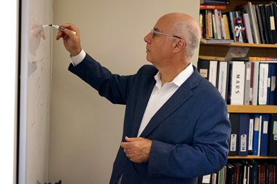 Noureddine Melikechi writes on a whiteboard.