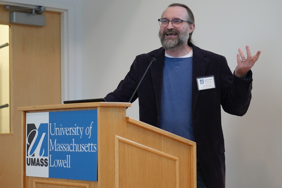 Mathew Barlow in front of a University of Massachusetts Lowell podium.