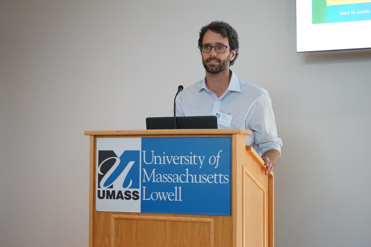 Christopher Skinner in front of a University of Massachusetts Lowell podium.