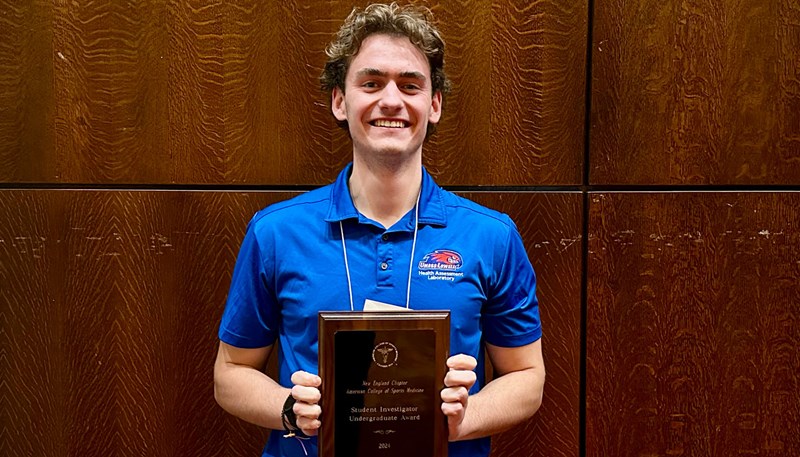 Donald Rogers holding award.