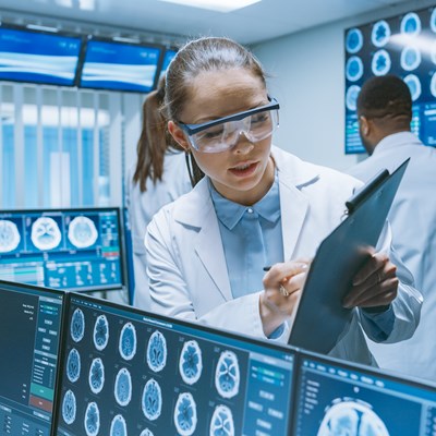 Scientists analyzing brain scans in a lab.