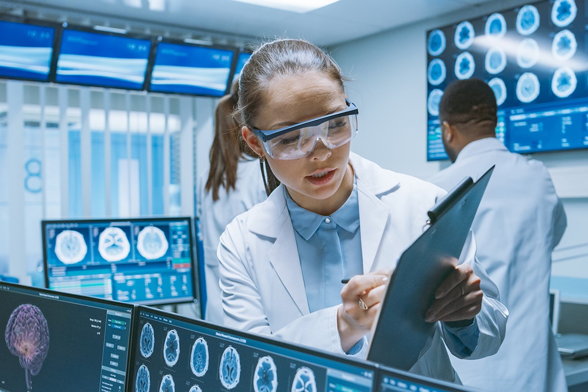 Scientists analyzing brain scans in a lab.