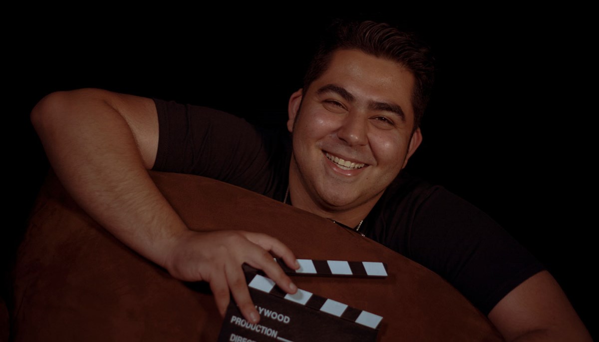 Fahad Alden holding a director's clapperboard.