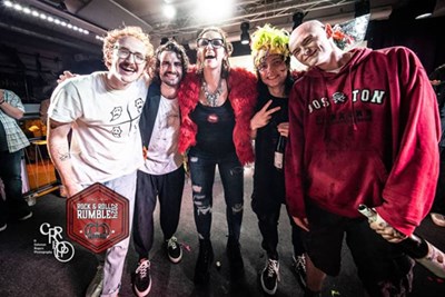 The Ghouls band pose with DJ Anngelle Wood after being crowned champs of the Rock and Roll Rumble