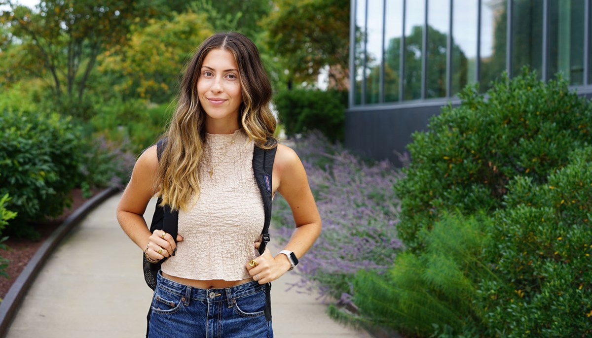 Hope Zouzas poses for photo outside of the Manning School of Business.