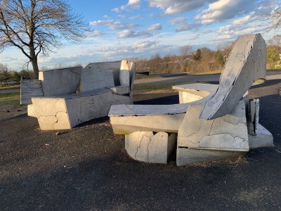 Chairs and benches of concrete on asphalt surface