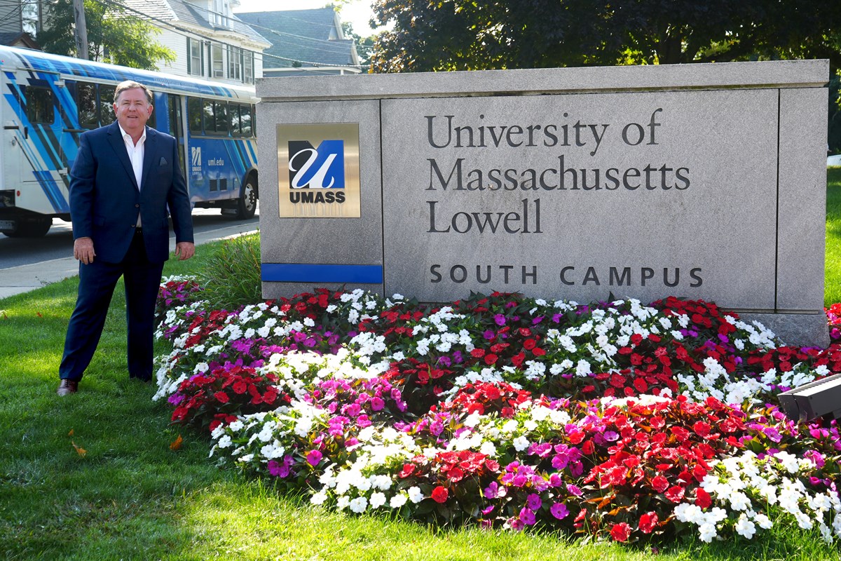 Jay Lang next to the University of Massachusetts Lowell South Campus sign.