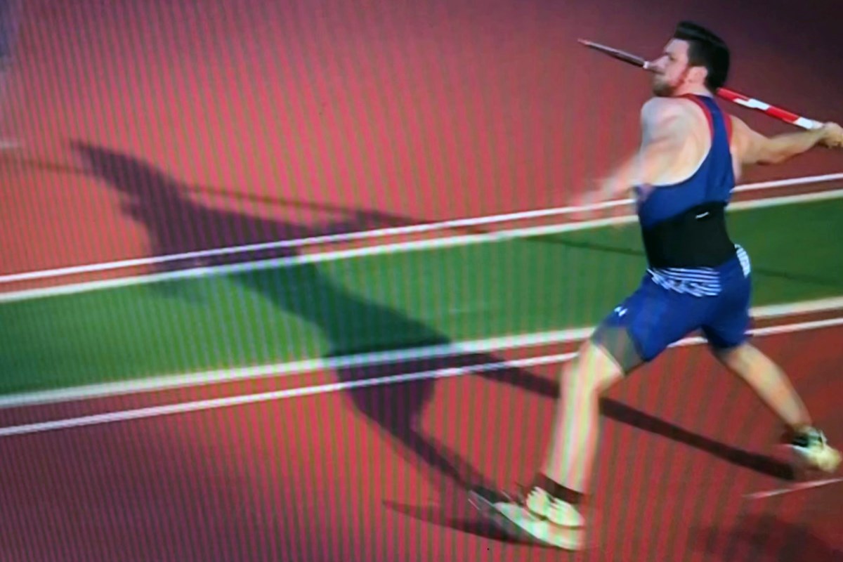 A screengrab of a person throwing a javelin during a track meet.