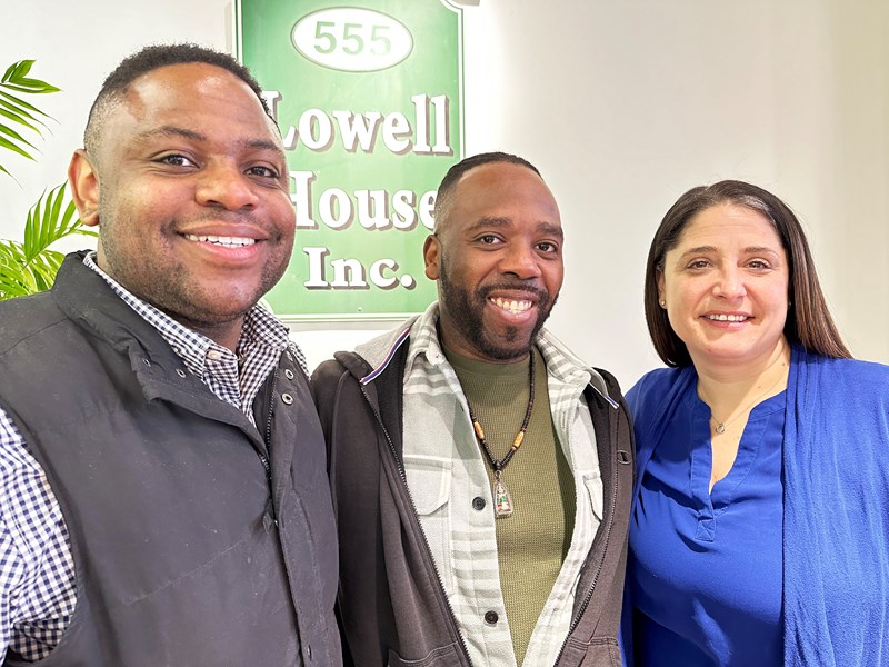 Marcus Whitlow poses for a group photo at 555 Lowell House Inc.