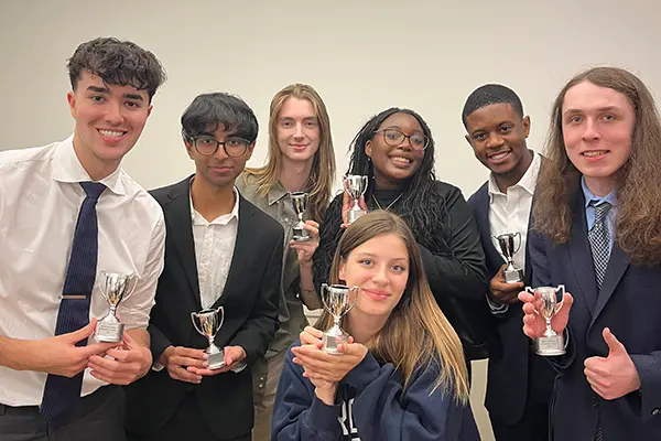 Seven students on the UML Mock Trial team posing with individual awards