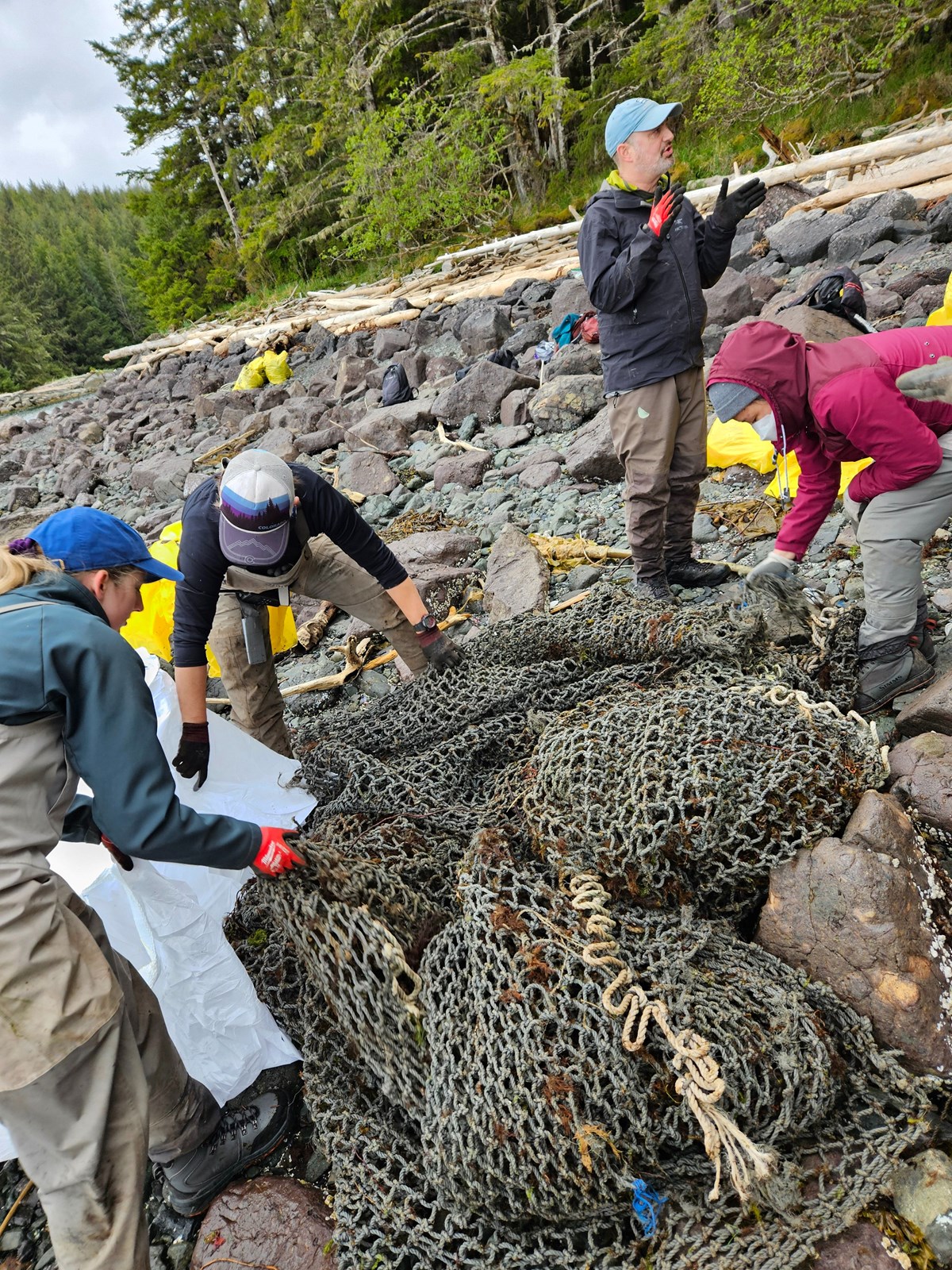 Graduate students working to clear fishing gear from the shoreline.