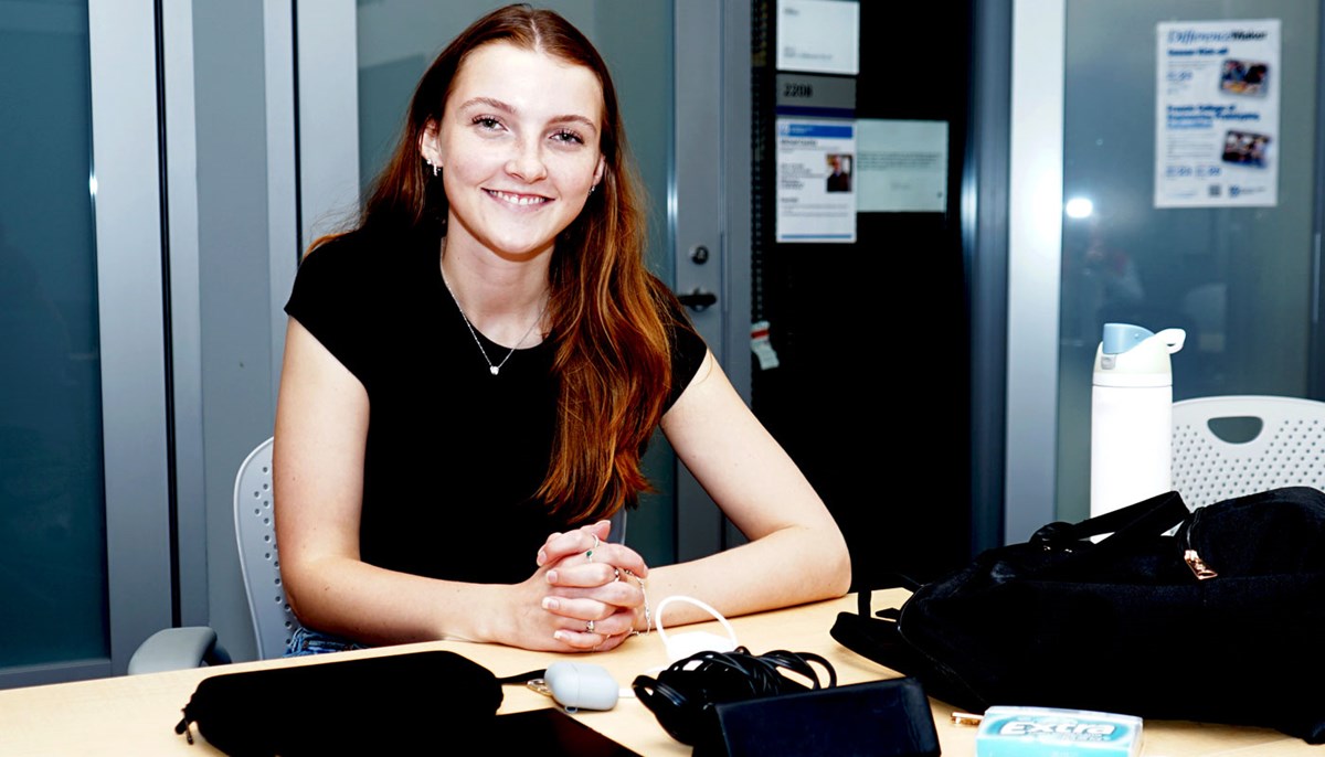 Nicole Karp sits at a desk.